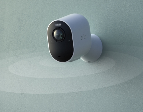 An Arlo security camera hanging on a wall with an effect showing the extra-wide field-of-views captured by the camera